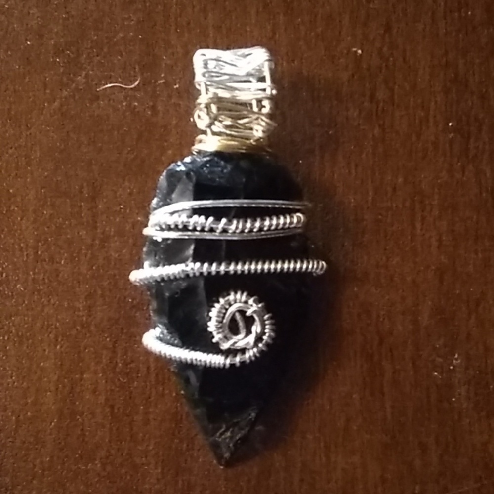 Obsidian wrapped in silver plated wire.